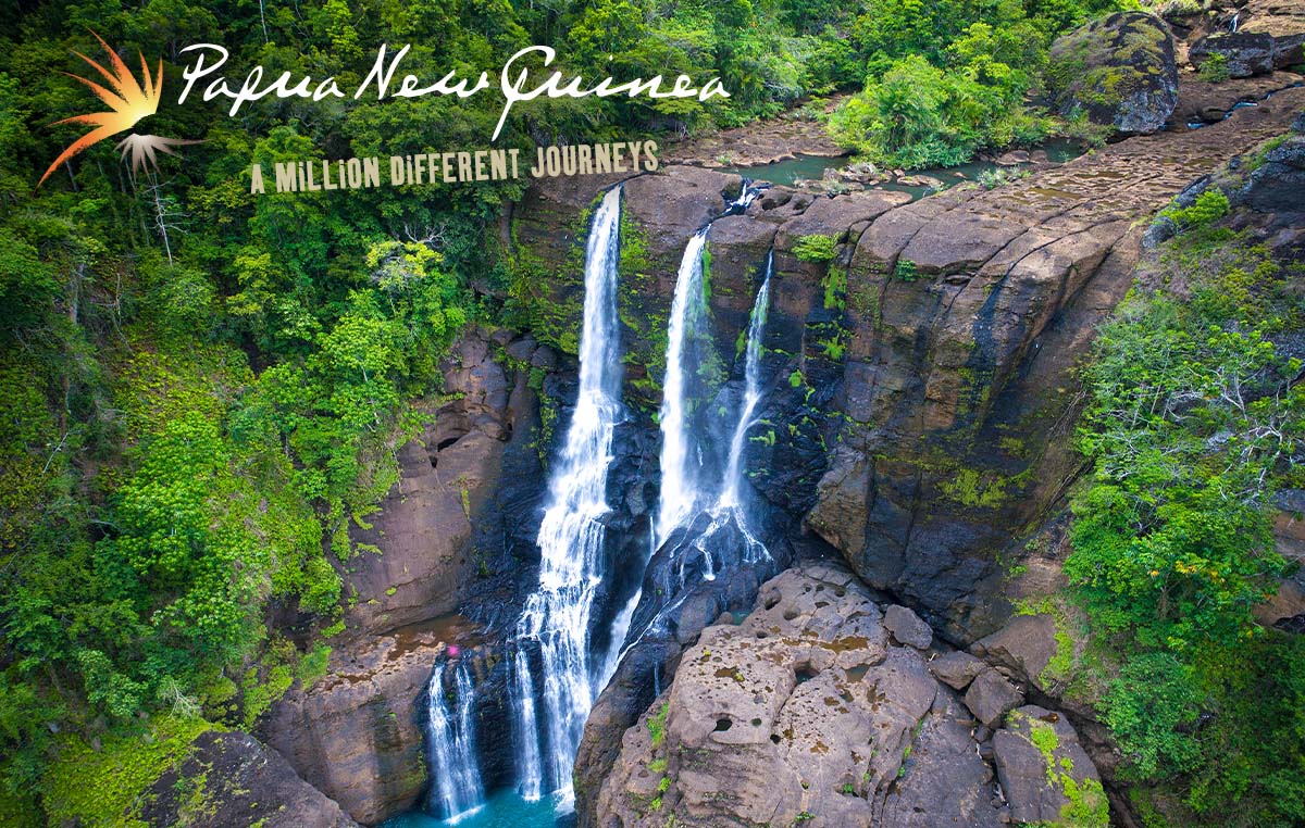 Papua New Guinea - a million different journeys. A beautiful waterfall flowing to a small pool in a lush forest.