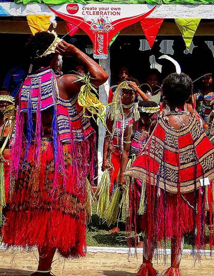 A group of individuals standing while dressed in traditional clothing.