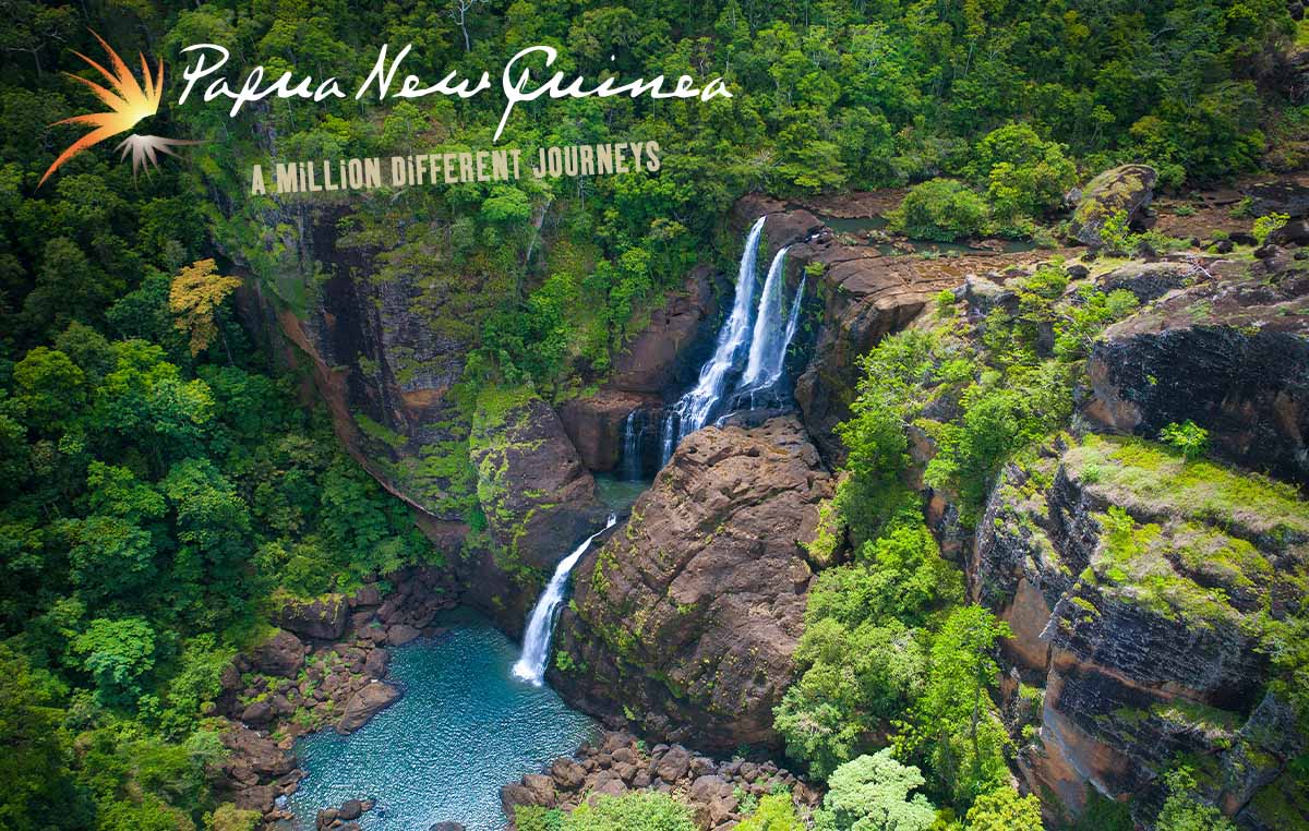 Papua New Guinea - a million different journeys. A beautiful waterfall flowing to small pool in a lush forest.